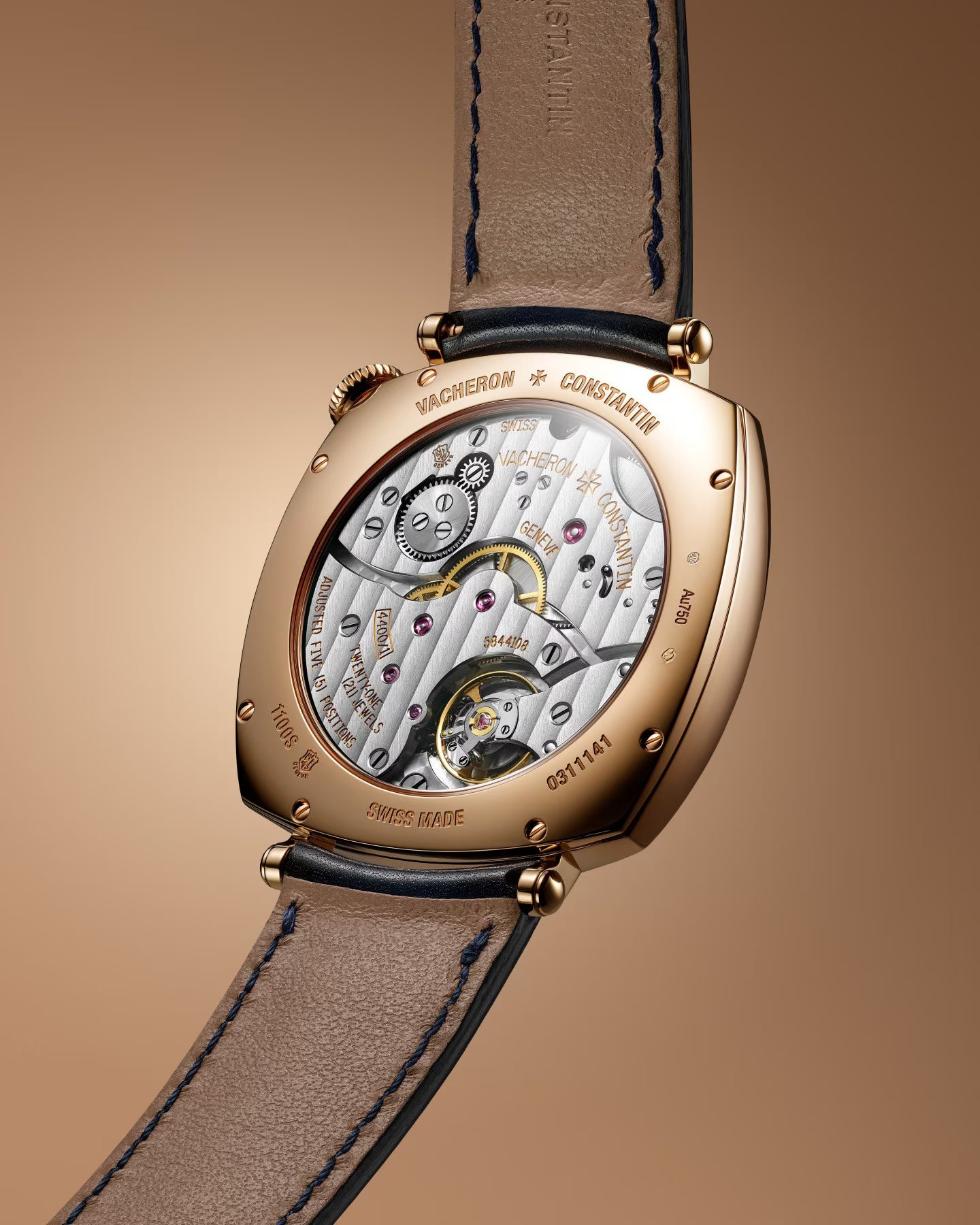 Rose gold tonneau watch with exposed mechanical movement, black leather strap, and visible gears through transparent caseback