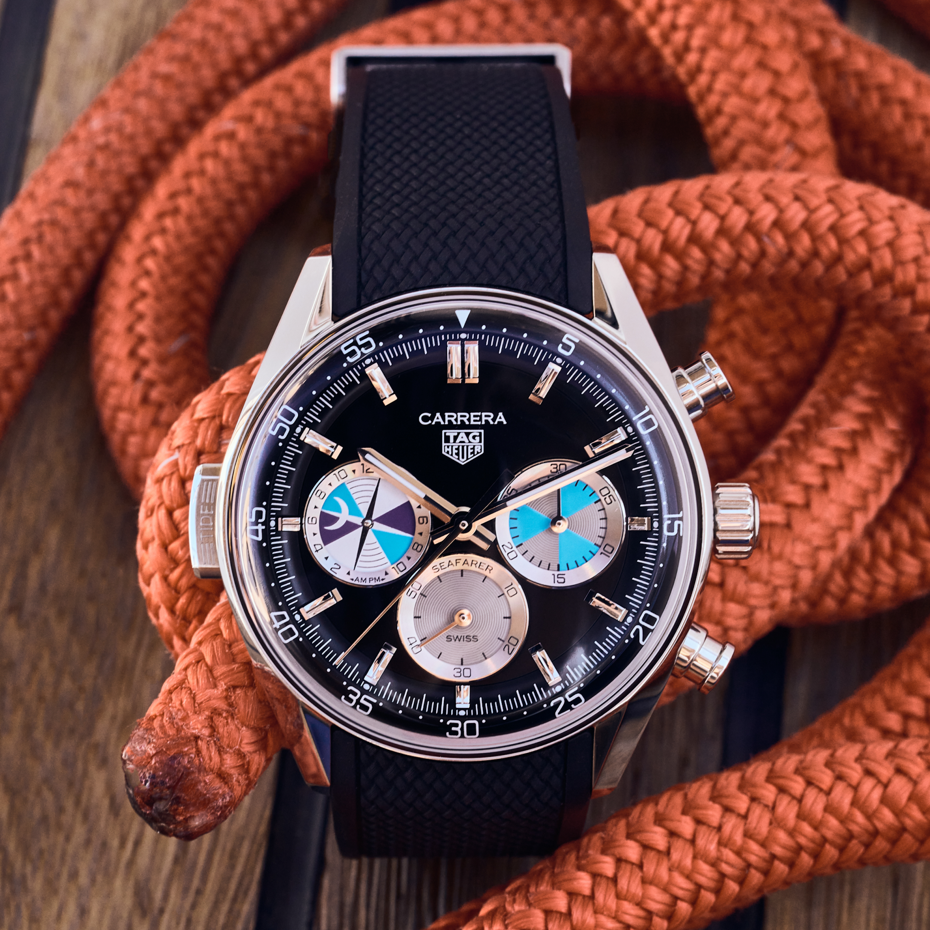 The TAG Heuer Carrera Chronograph Seafarer × Hodinkee watch by TAG Heuer, featuring three subdials, is displayed resting on an orange braided rope.