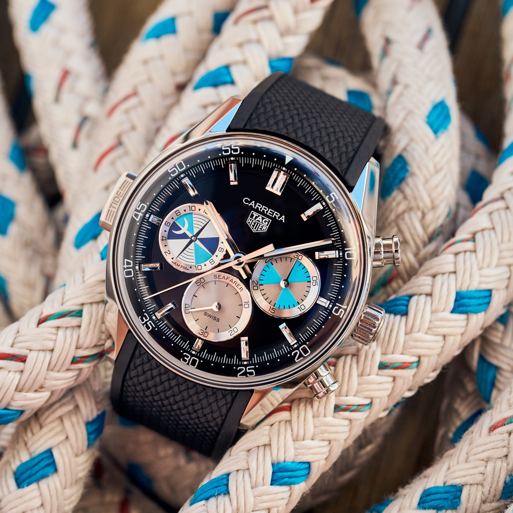 A TAG Heuer Carrera Chronograph Seafarer × Hodinkee watch by TAG Heuer, featuring a black strap, rests on coiled white ropes with blue accents.