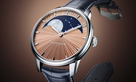 Luxury wristwatch with a starburst dial, moonphase display, and blue leather strap on a brown gradient background.