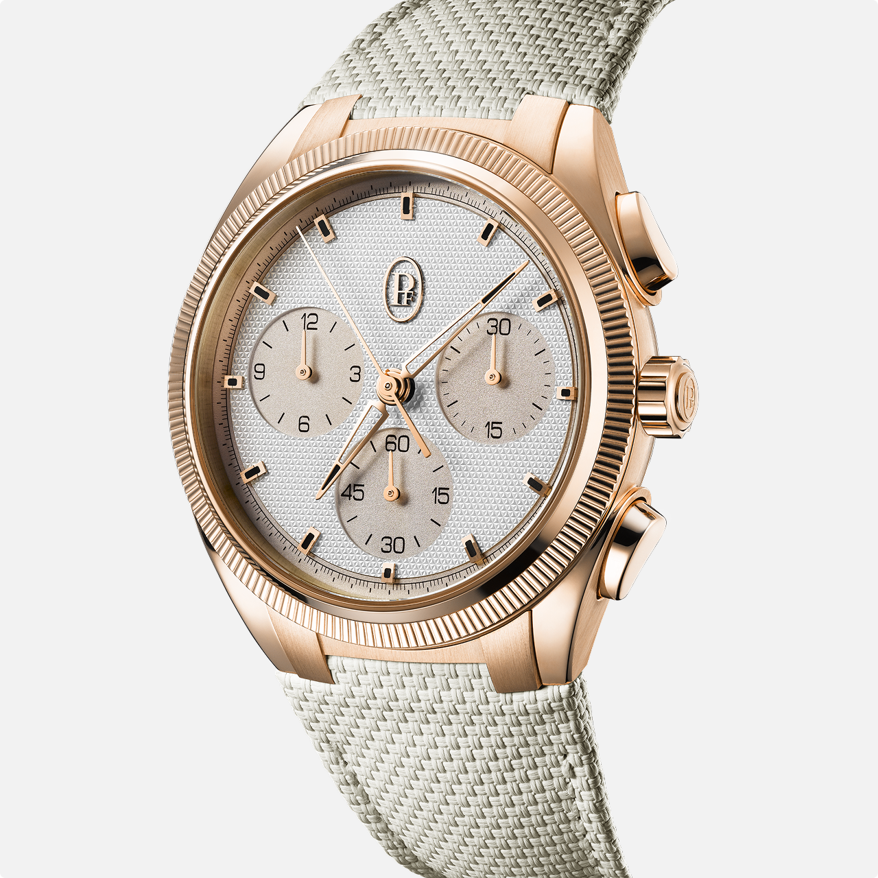 The Parmigiani Fleurier TONDA PF Sport is a gold chronograph wristwatch featuring a white textured dial and beige fabric strap, shown against a white background.