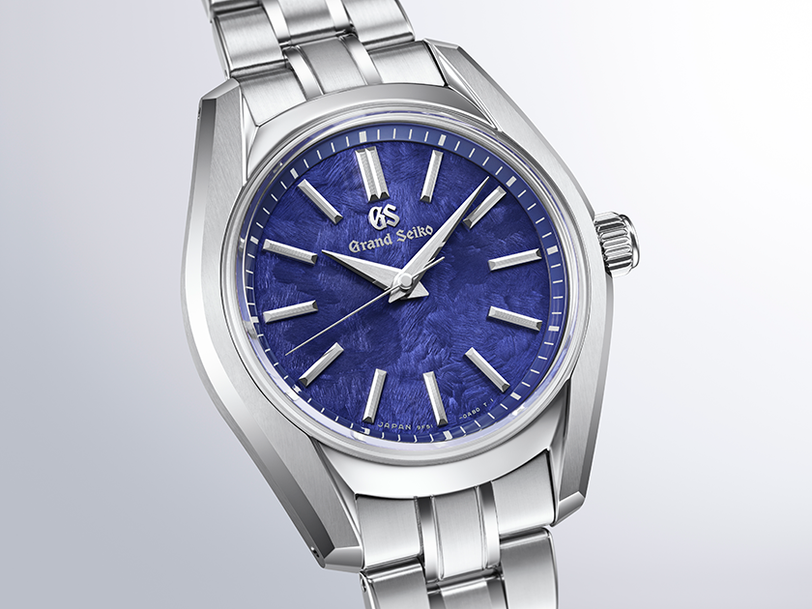 Silver stainless steel watch with blue dial, silver hour markers, and matching metal bracelet.
