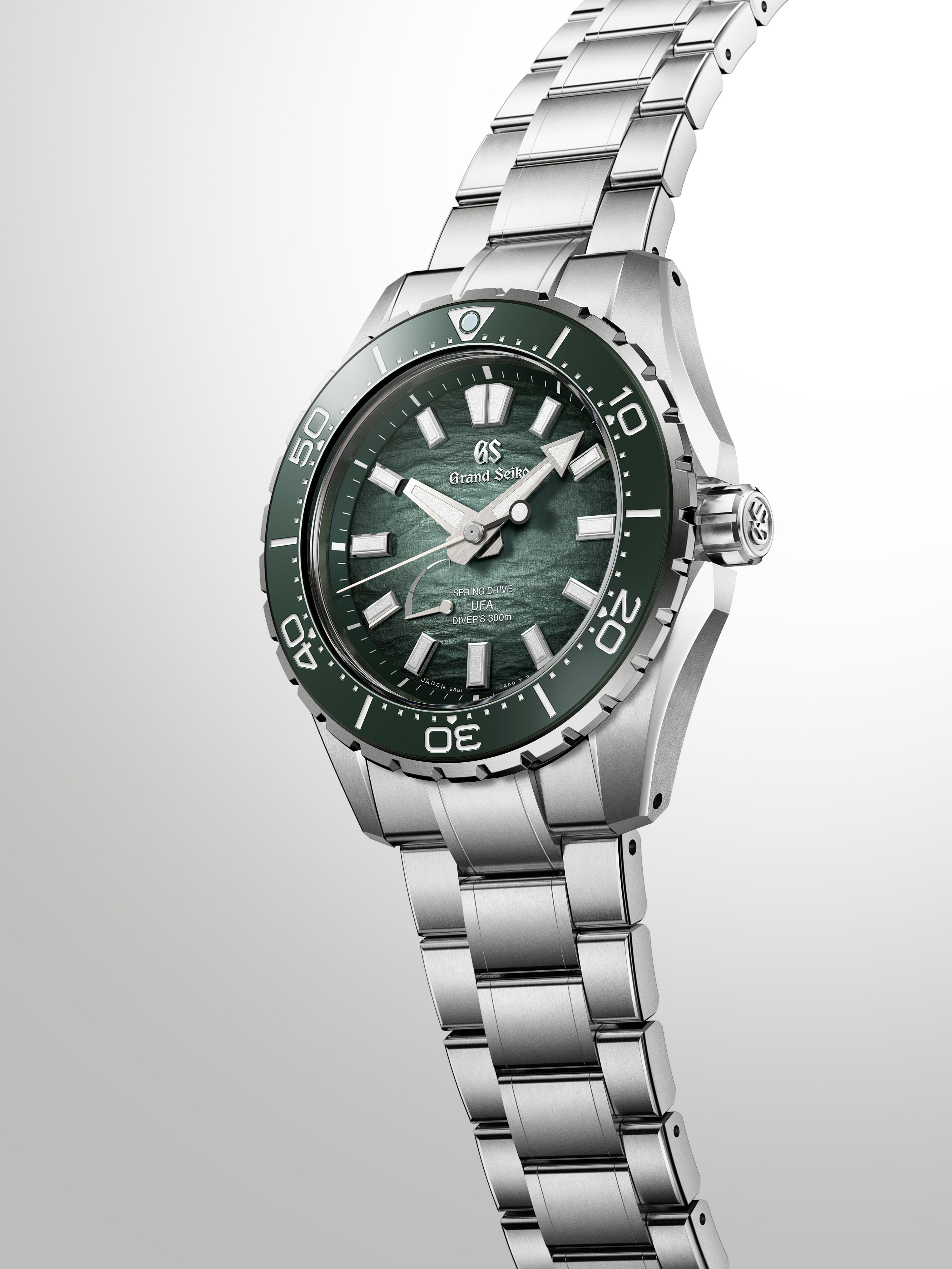 Grand Seiko Spring Drive diver watch with green sunburst dial, stainless steel case and bracelet, rotating bezel marked to 70
