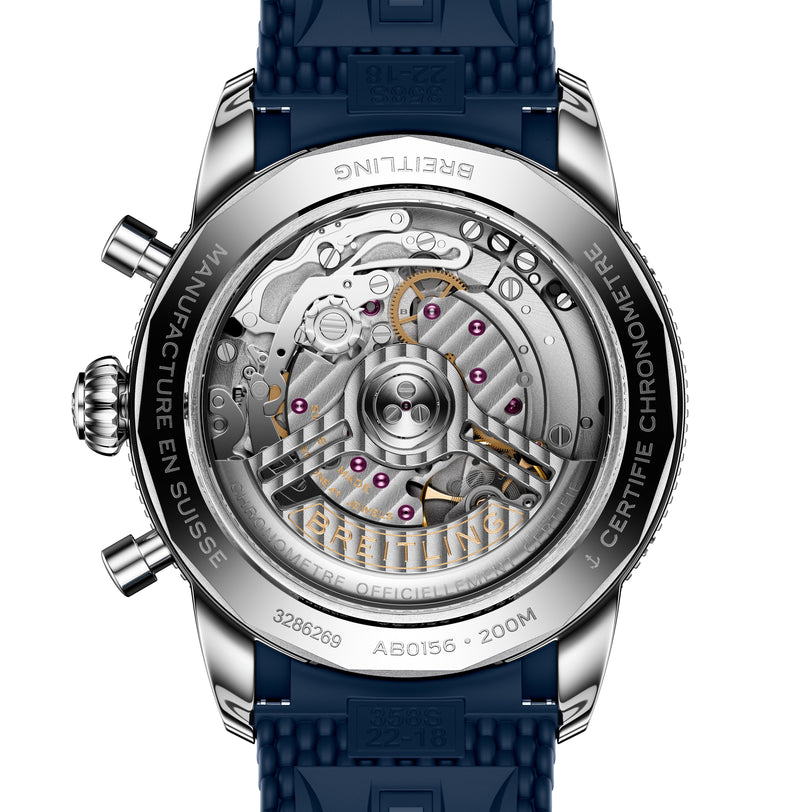 Close-up of the Breitling Superocean Heritage B01 Chronograph 42’s transparent case back reveals its intricate mechanical movement and blue strap.