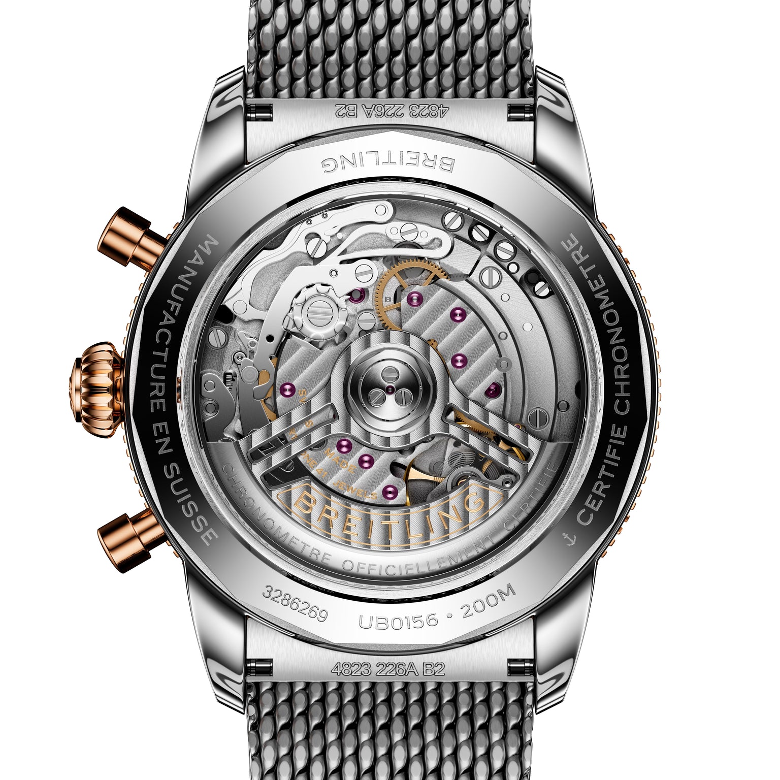 Close-up of the Breitling Superocean Heritage B01 Chronograph 42 watch back, revealing its detailed mechanical movement and metal mesh strap.