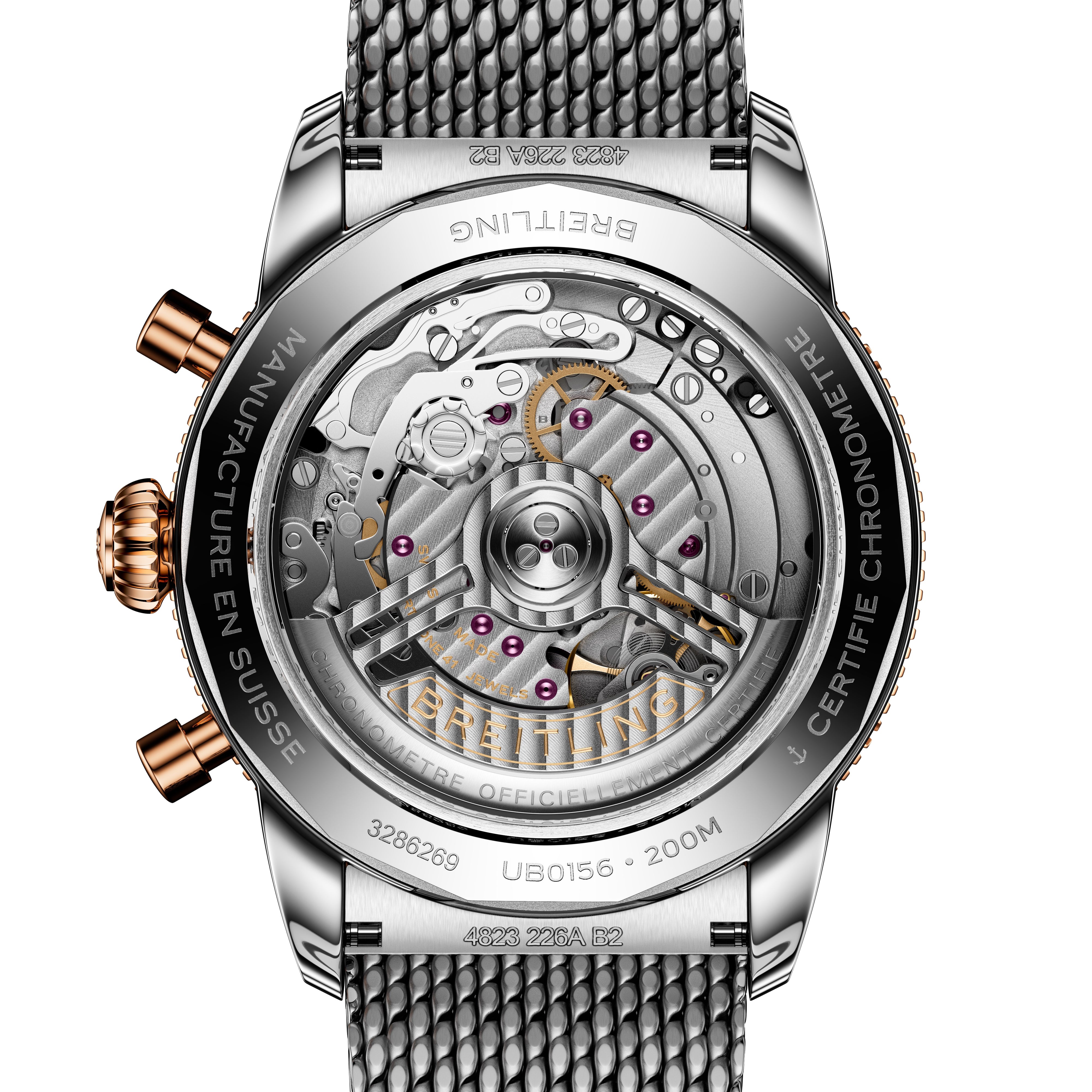 Close-up of the Breitling Superocean Heritage B01 Chronograph 42 watch back, revealing its detailed mechanical movement and metal mesh strap.