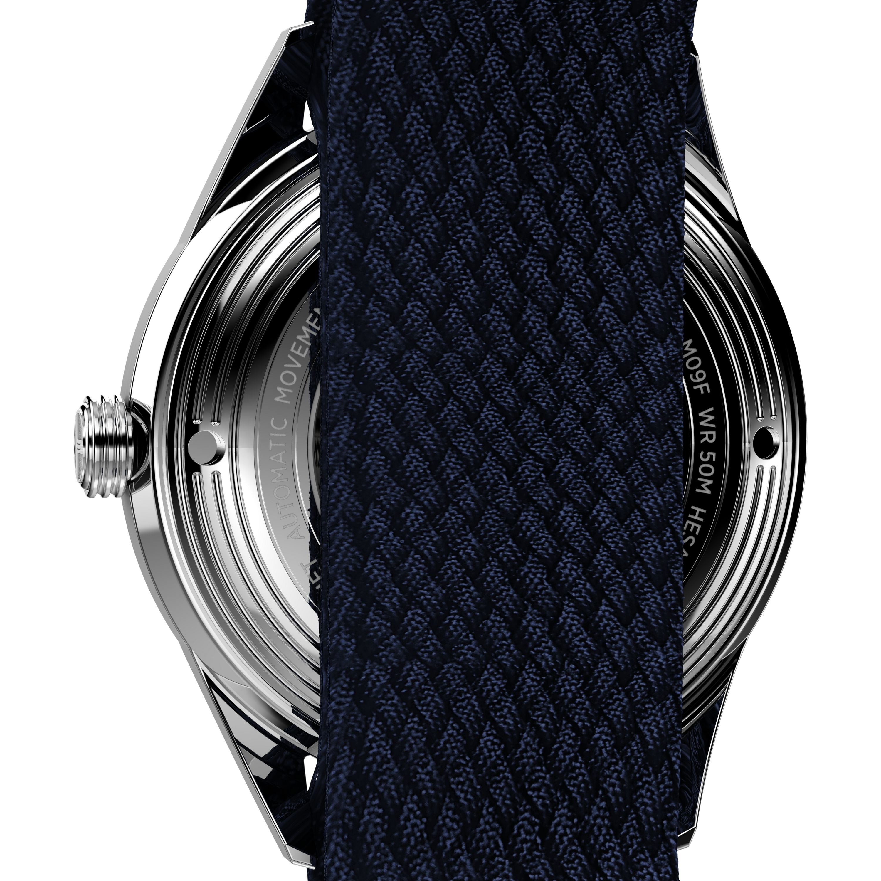 Close-up of the back of the Timex Marlin® Jet Automatic watch, with a dark textured fabric strap partially covering the metal case and engraved text.
