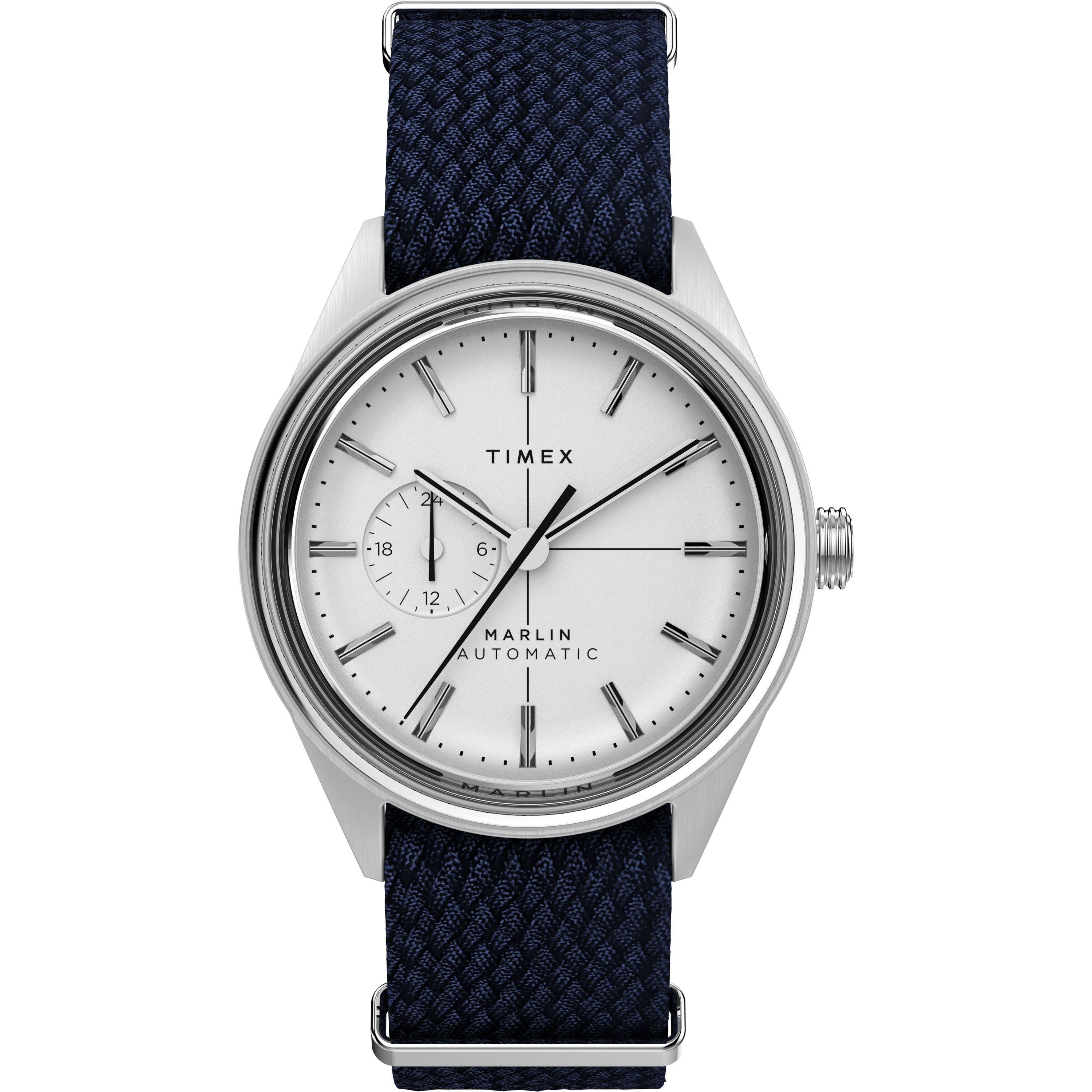 The Timex Marlin® Jet Automatic features a white dial, silver markers, subdial at 9 o’clock, textured navy blue fabric strap, stainless steel case, and domed Hesalite crystal for a sleek retro-futuristic look.