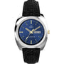 The Timex Q 1978 Day/Date is a retro dress watch with a blue dial, gold-tone hands and markers, black leather strap, silver-tone round case, and quartz movement powering a day-date display on the right.