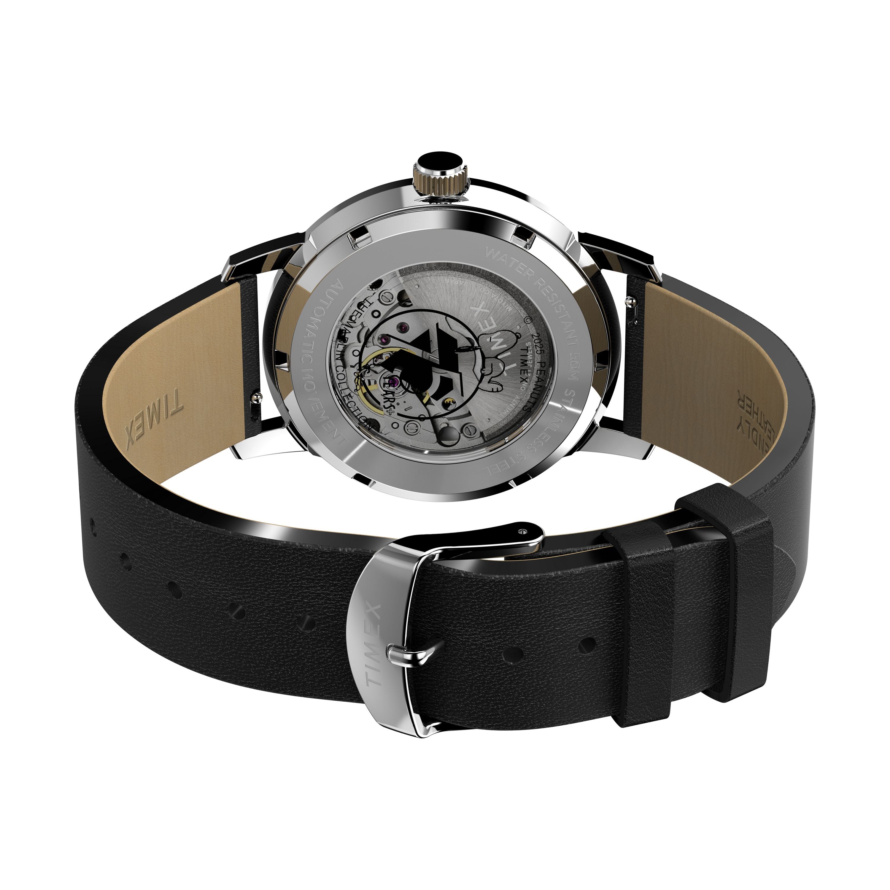 A close-up of the Timex x Peanuts® Marlin® Automatic 75th Anniversary Edition shows its exposed mechanical movement through a transparent case back, with the black leather strap, buckle, and inner strap details visible.