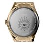 The Timex x Jacquie Aiche wristwatch features a gold case back engraved with an eye illustration, branding, and WR50M—a true Guiding Light timepiece from Timex.