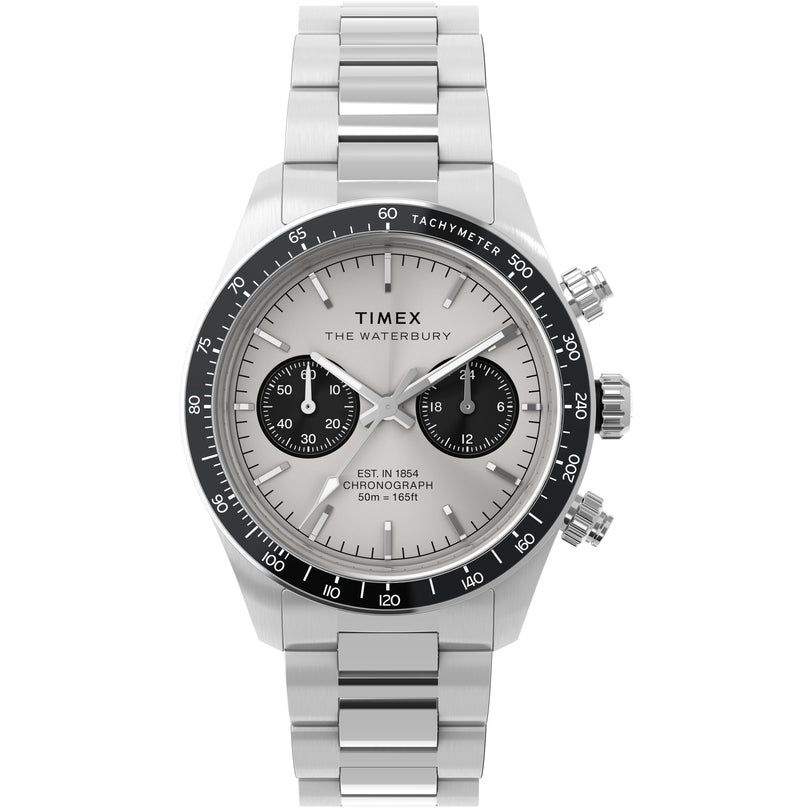 The Timex Waterbury Heritage Chronograph features a silver stainless-steel bracelet, white dial with black subdials, black tachymeter bezel, three pushers, and displays the date along with hours, minutes, and seconds.