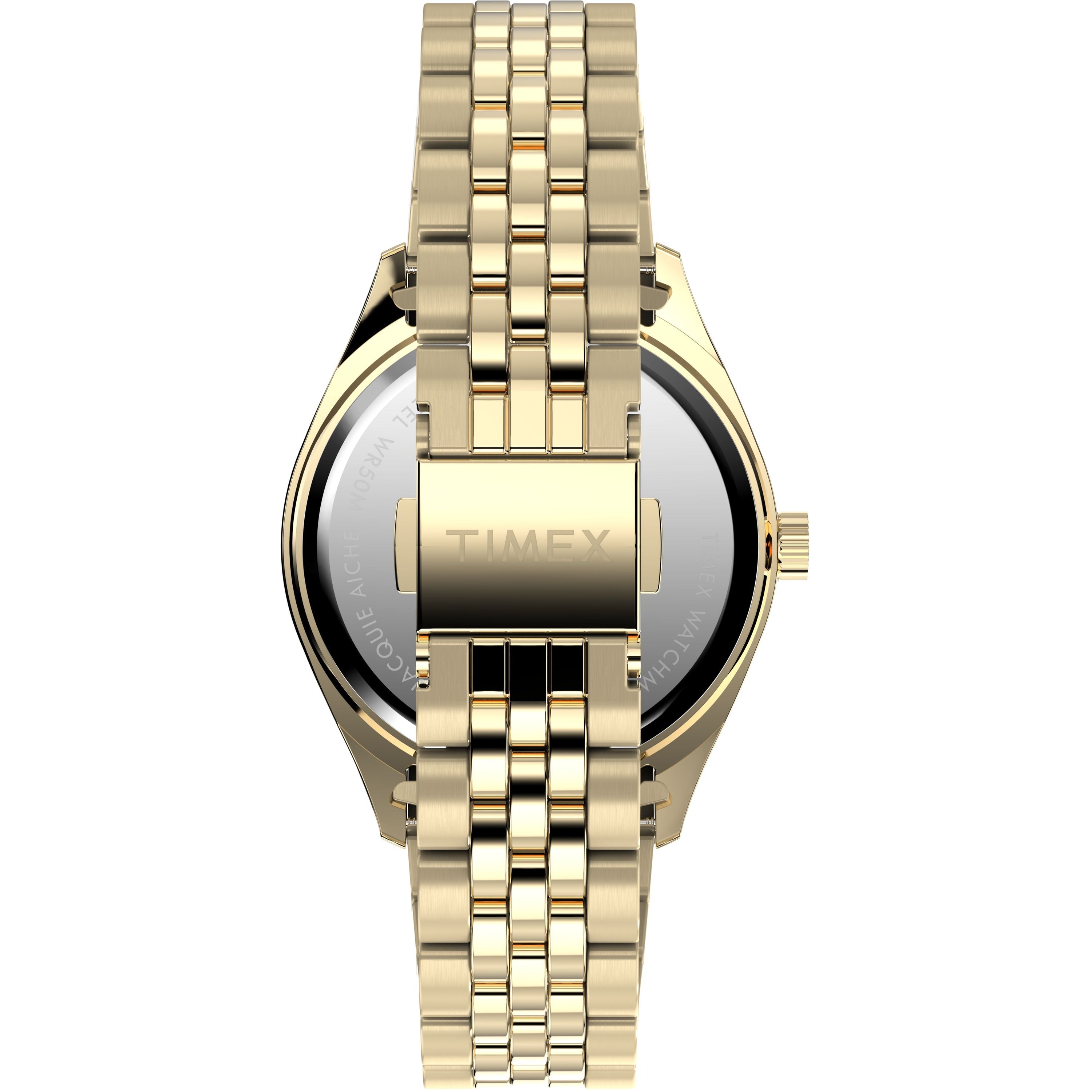 A gold-tone Timex x Jacquie Aiche wristwatch shown from the back, featuring a linked metal band and engraved Timex clasp. The polished case and silver case back complete this elegant Timex timepiece.