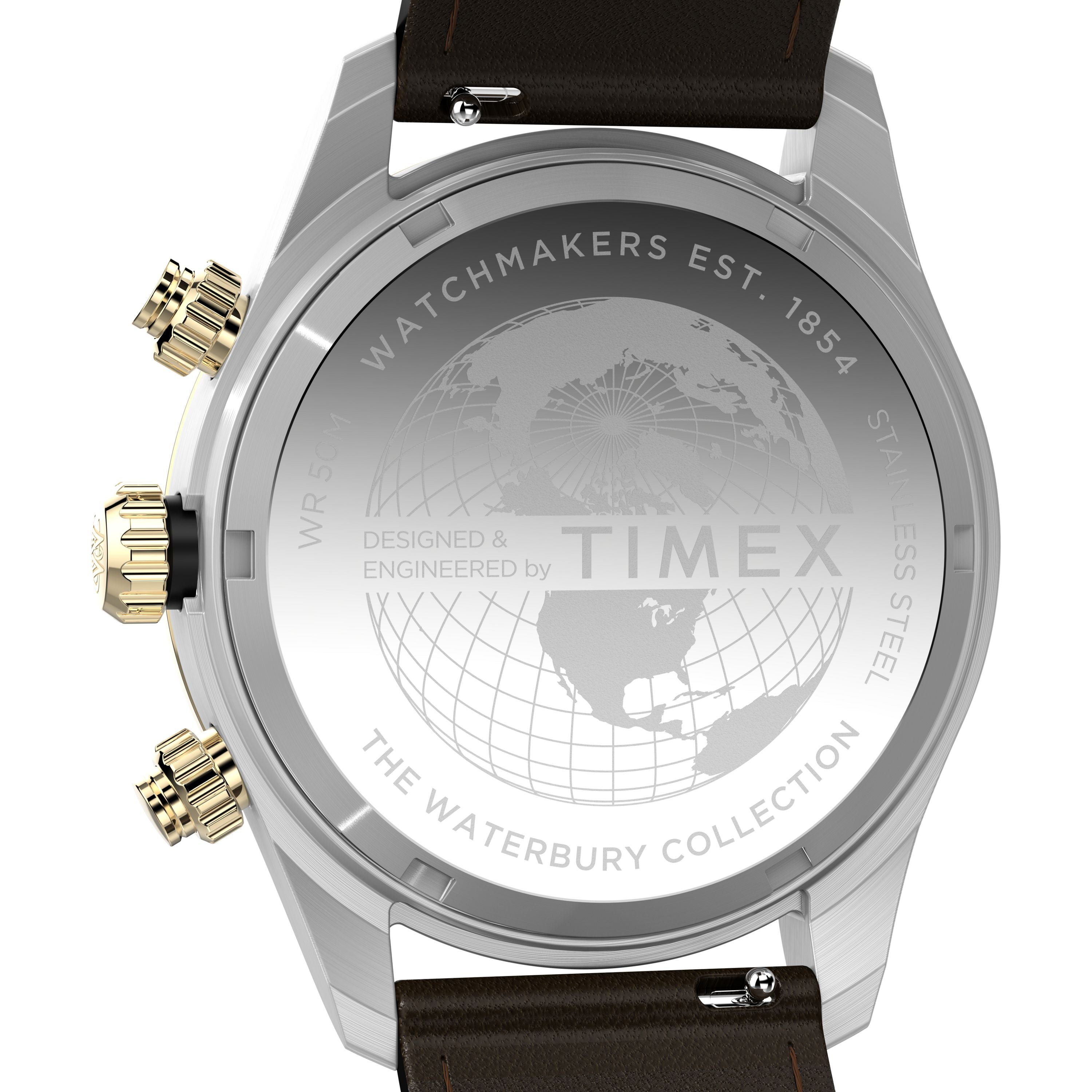 Back of the Timex Waterbury Heritage Chronograph shows engravings like a world map, “Watchmakers Est. 1854,” and “The Waterbury Collection,” plus gold/silver pushers on the stainless steel case and a brown leather strap.