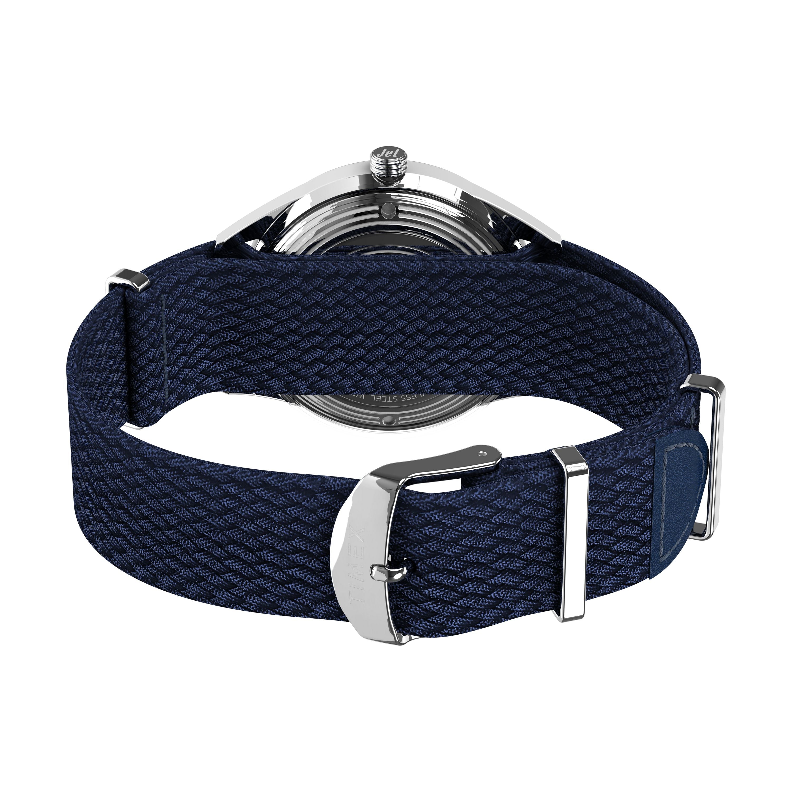 A close-up view of the Timex Marlin® Jet Automatic showcases its blue textured fabric strap with a silver buckle, highlighting the retro-futuristic case underside and detailed strap design from the back.