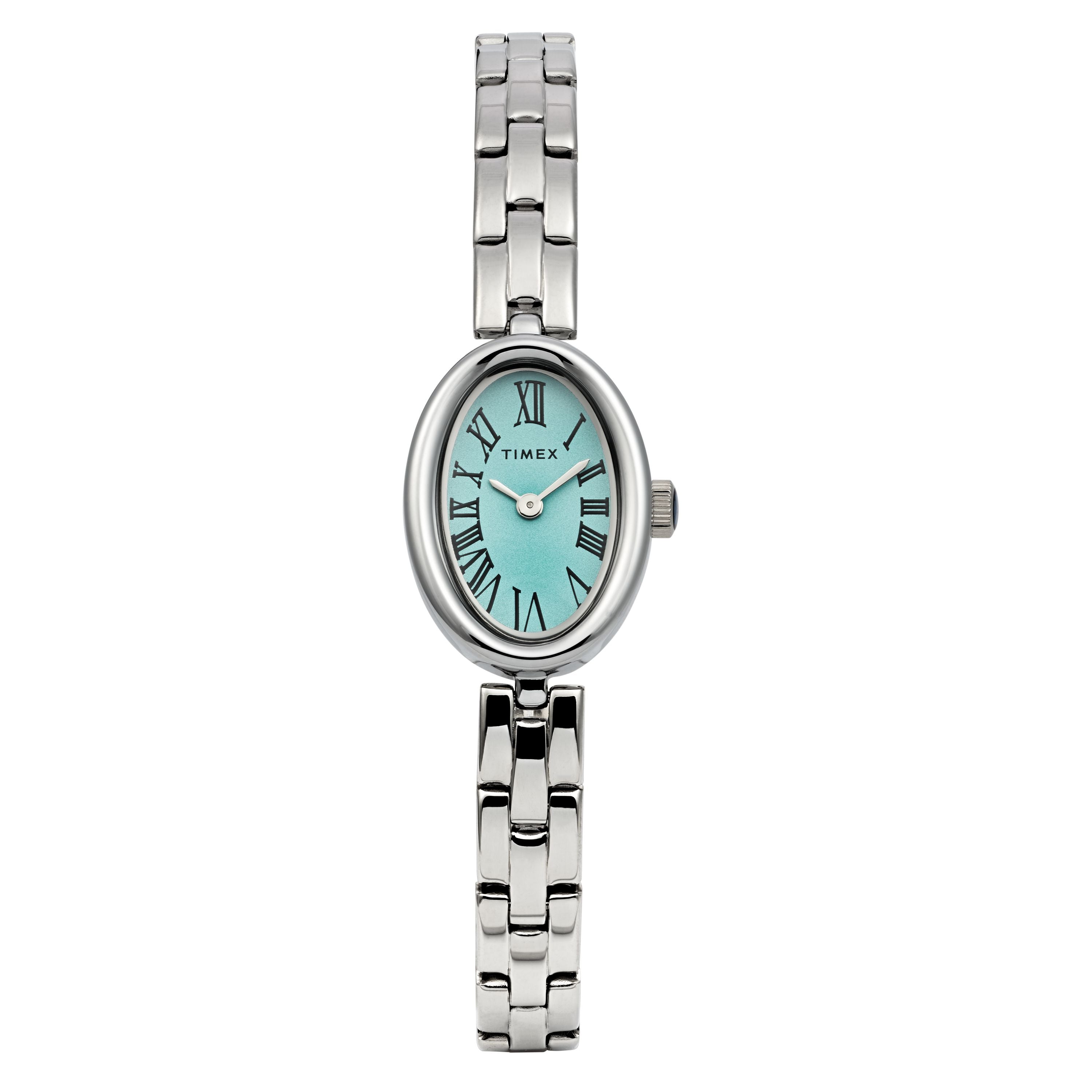 The Timex Cavatina features a silver-tone case and bracelet with an aquamarine dial, black Roman numerals, and an oval face. The Timex logo is visible on the dial.