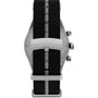 The Timex Waterbury Heritage Chronograph is shown from the back with a black recycled fabric strap featuring a gray center stripe and metal clasp engraved with the TIMEX logo.