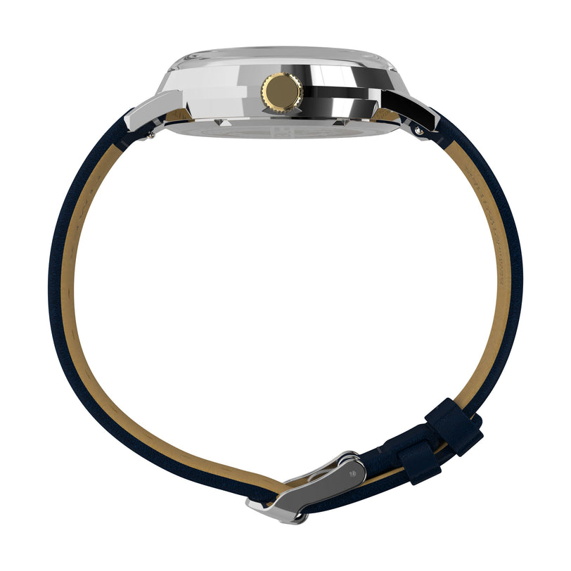 Side view of the Timex Marlin® Quartz GMT, a dual time zone watch with shiny silver case, gold crown, vintage domed acrylic crystal, and blue leather strap with silver buckle, displayed on a white background.