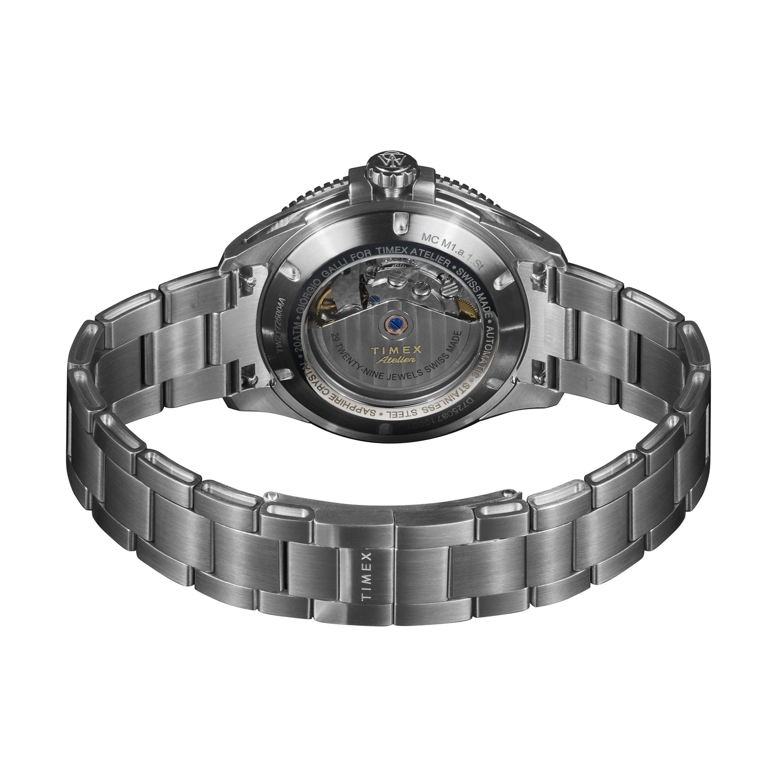 A close-up of the Timex Atelier Marine M1a Swiss Made Automatic highlights its minimalist design, transparent case back revealing the mechanism, and an open metal bracelet with “TIMEX” engraved on the clasp.