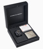 The Porsche Design Chronograph 1 Hodinkee 2024 Edition watch is presented in a black box with certificates and a plaque beside it.
