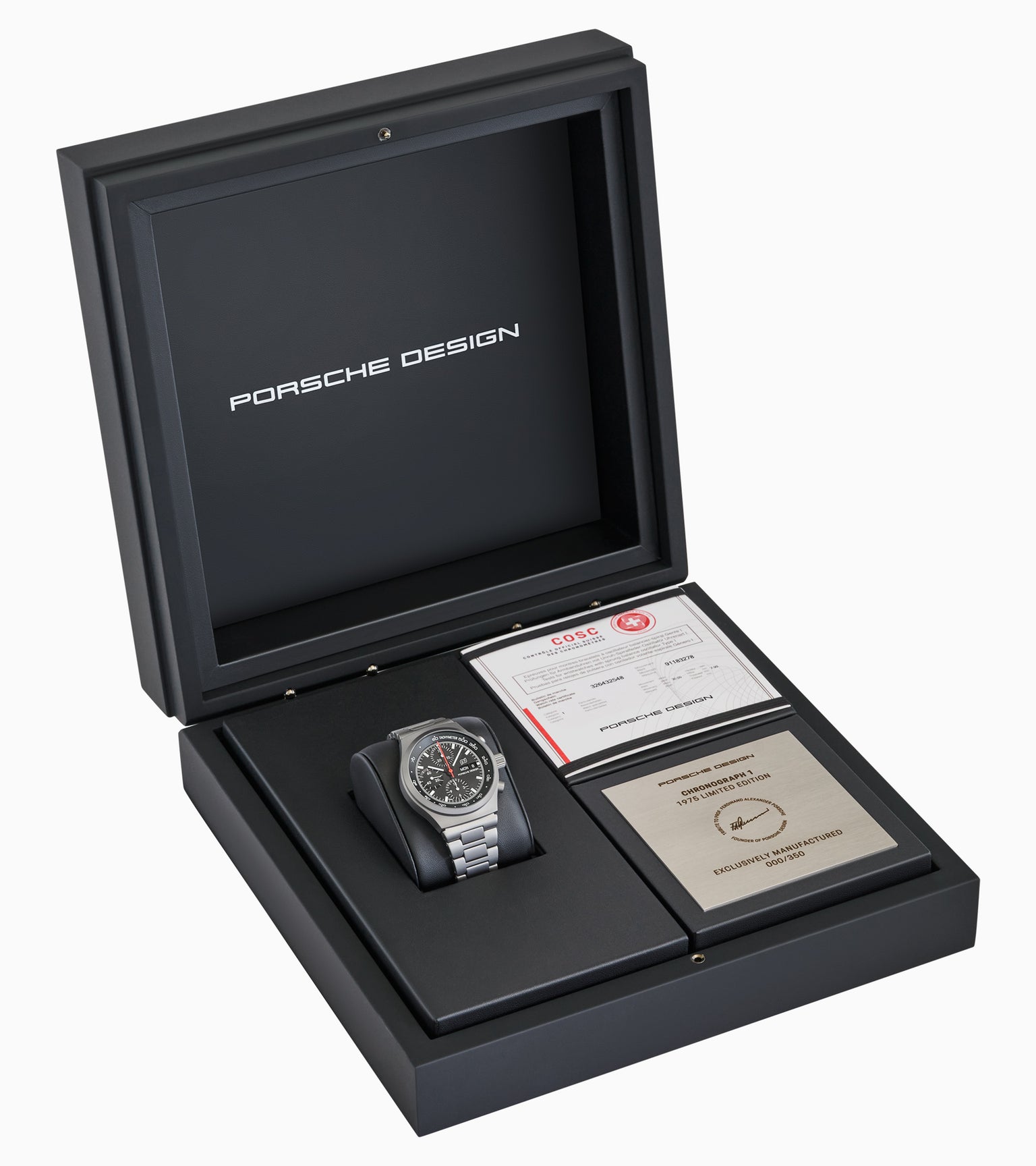 The Porsche Design Chronograph 1 1975 Limited Edition watch is shown in a black box with certification cards and documents beside it.