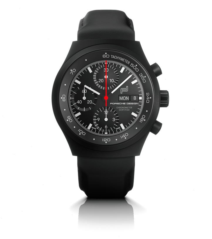Black chronograph watch with tachymeter bezel, multiple subdials, day-date window, and red center hand on black leather strap