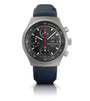Titanium chronograph watch with black dial, tachymeter bezel, date window, and dark blue rubber strap.