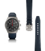 Titanium chronograph watch with black dial, red seconds hand, and dark blue rubber strap shown with buckle and full strap len