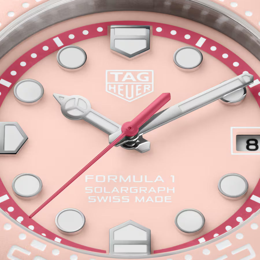 Tag Heuer watch with pink and silver design on a white background