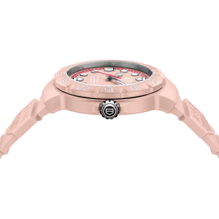 Pink wristwatch with detailed design on a white background