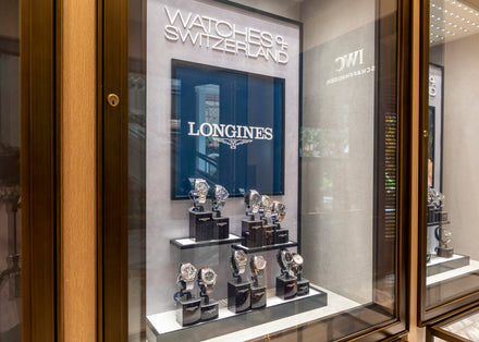 Display case with several luxury Longines watches at a Watches of Switzerland store.
