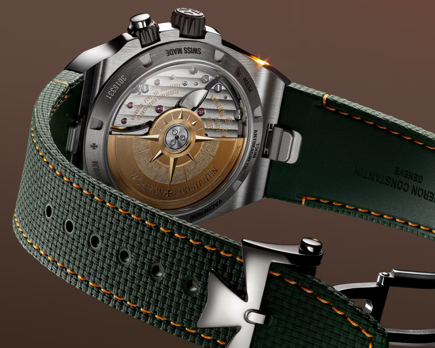 Chronograph watch with bronze dial featuring cardinal points, stainless steel case, and green fabric strap with orange stitch