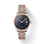 Tissot watch with two-tone rose gold and silver bracelet on a white background