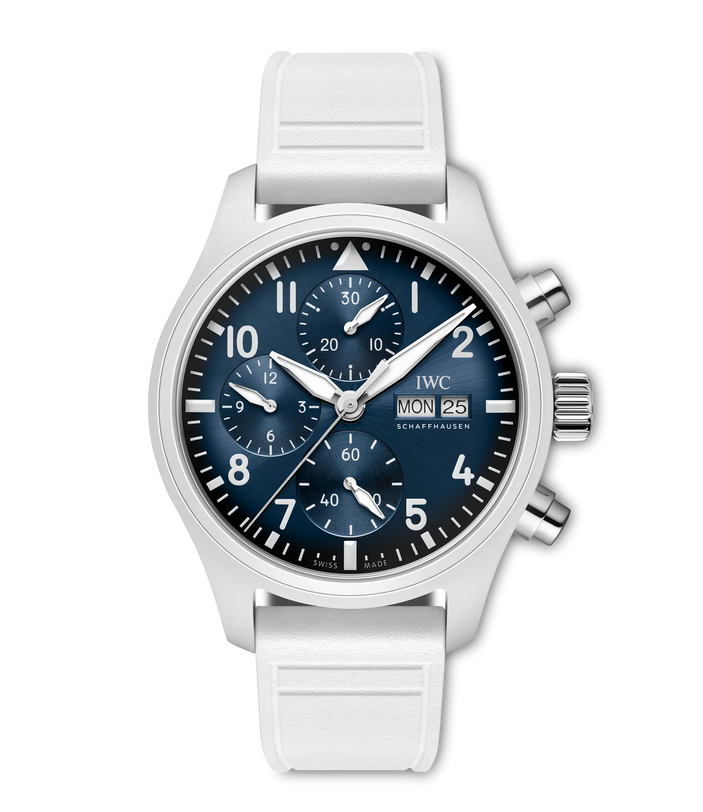 Stainless steel chronograph watch with dark blue dial, white numerals, date window, and white rubber strap.
