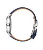 Round watch with silver case, navy blue strap with orange interior lining, and side crown.