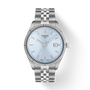Silver Tissot watch with a light blue face on a white background