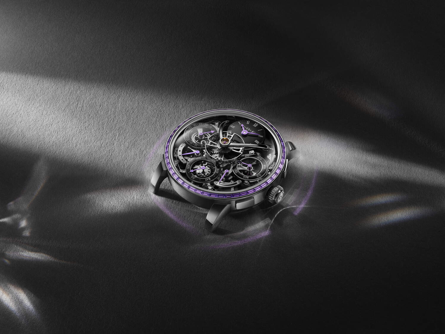 Luxury watch with intricate design on a dark fabric background
