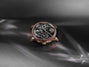 Luxury watch with intricate design on a dark fabric background