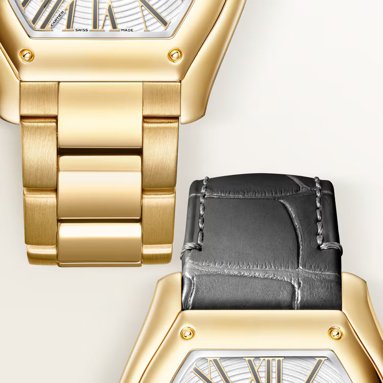 Gold-tone watch with rectangular face and striped dial, shown with interchangeable black leather strap and gold link bracelet