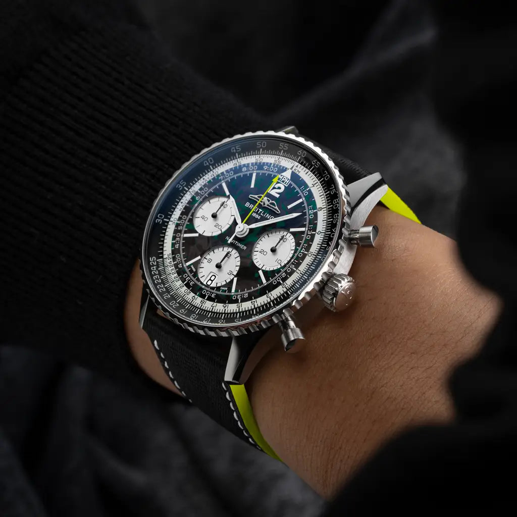 Luxury watch with a detailed face on a person's wrist against a dark background