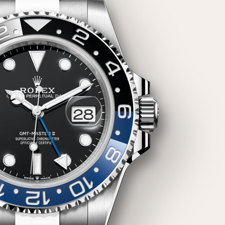 Close-up of a Rolex GMT-Master II watch with a black and blue bezel, black dial, and silver metal bracelet.