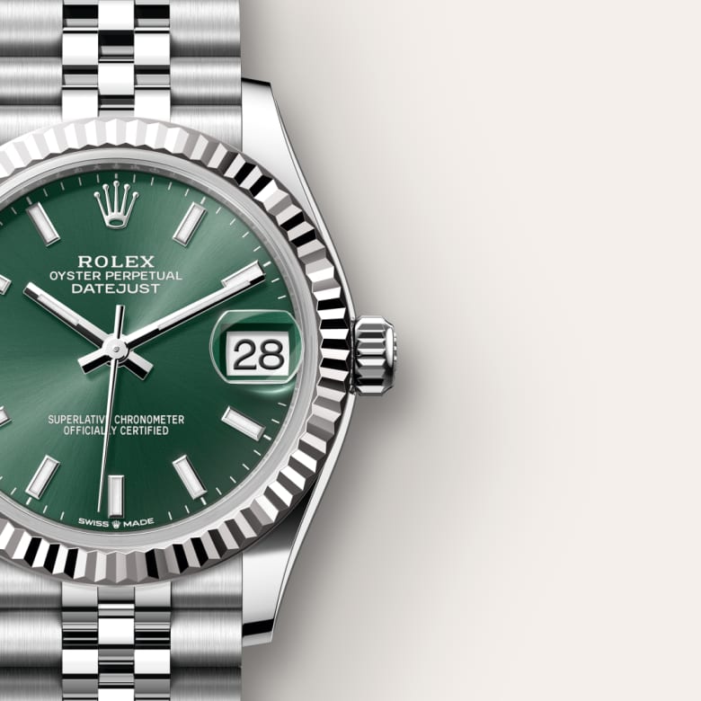 Silver Rolex Datejust watch with a green dial, date display, and silver metal bracelet on a light background.