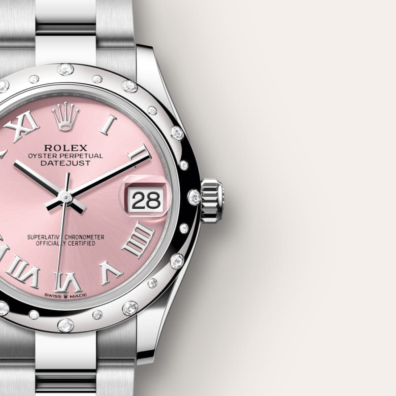 Close-up of a Rolex Datejust watch with a pink dial, diamond hour markers, and a silver metal band.