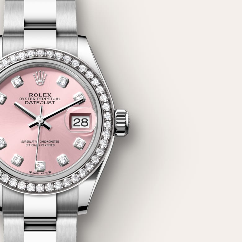 Silver Rolex watch with a pink dial, diamond hour markers, and a date display at 3 oclock.