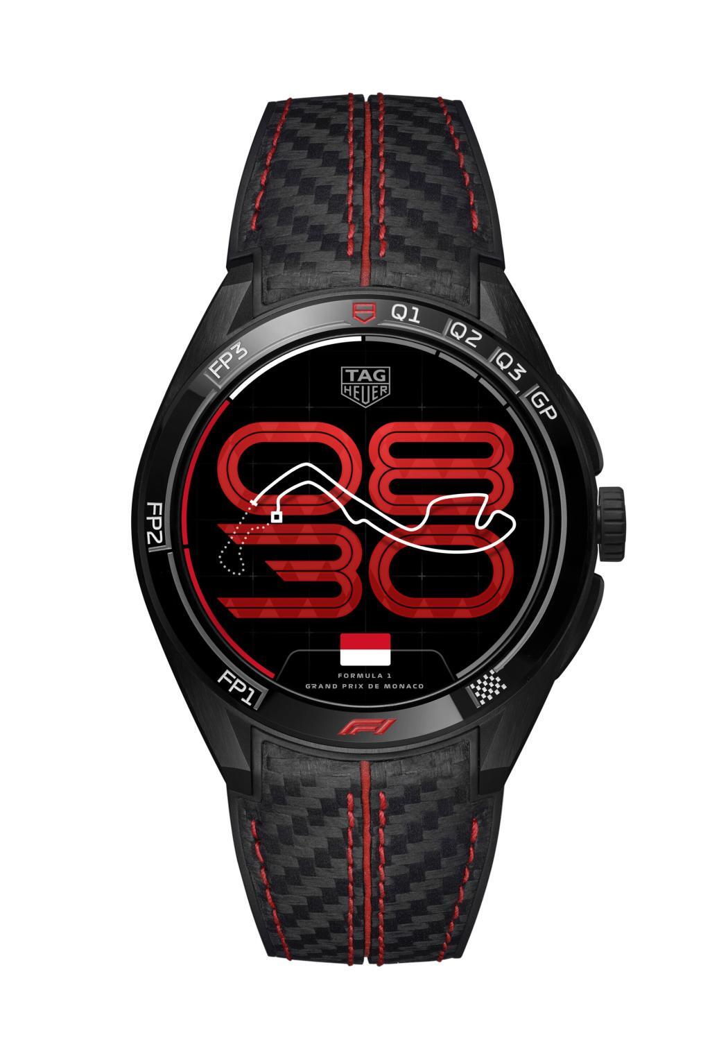 Watch with black carbon fiber strap and red accents on a white background