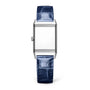 The Jaeger-LeCoultre Reverso Classic Monoface is a rectangular stainless steel watch with a plain face and textured blue leather strap, shown upright against a white background.