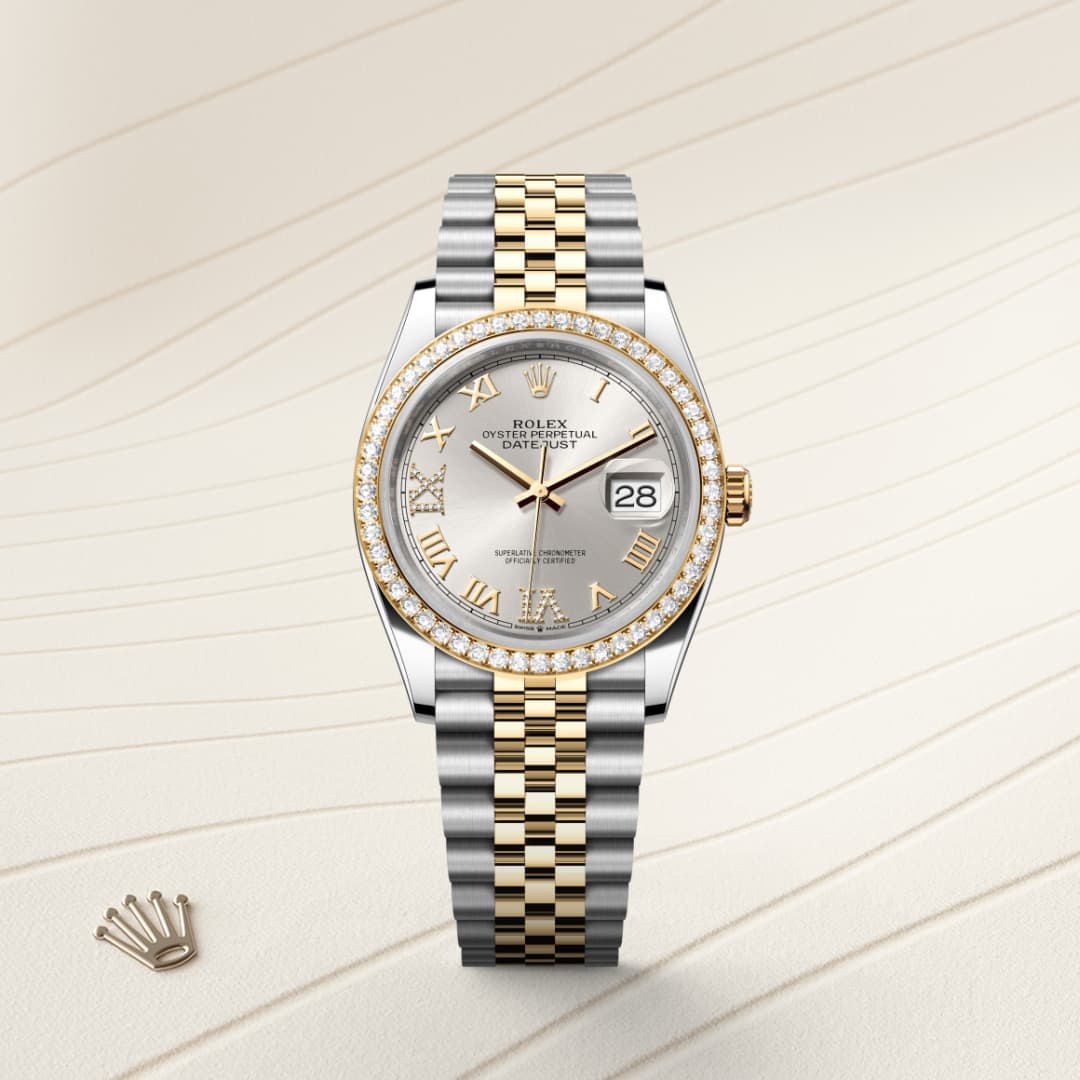 A two-tone gold and silver Rolex Datejust watch with diamond bezel and Roman numerals, displayed on a textured surface.