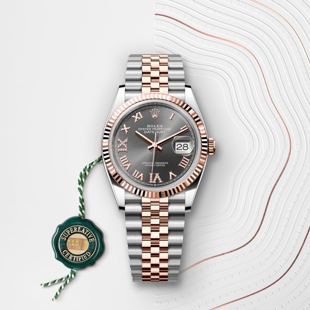 A Rolex Datejust watch with a two-tone metal band, black dial, Roman numerals, and a Superlative Certified tag.