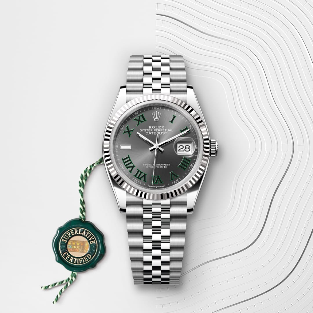A Rolex Datejust watch with a silver bracelet, green Roman numerals, and a Superlative Certified tag attached.
