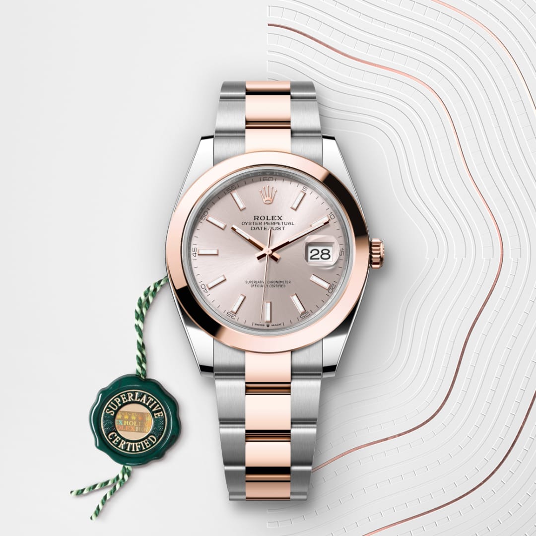 A silver and rose gold Rolex Datejust watch with a white dial and certification tag on a patterned background.